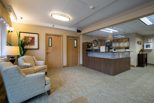 A cozy and inviting waiting room featuring comfortable seating and a reception desk.