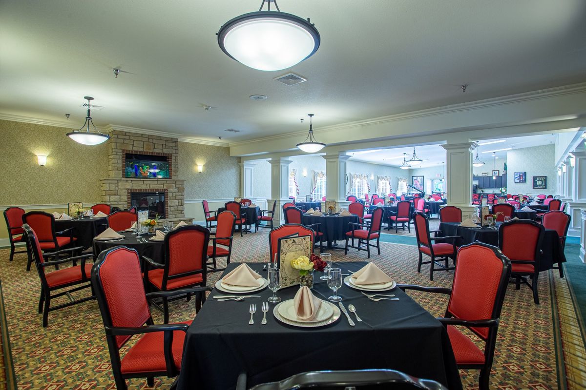 A spacious and elegantly decorated dining room with neatly arranged tables and chairs.
