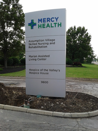 Sign for Mercy Health, displaying various healthcare services offered.