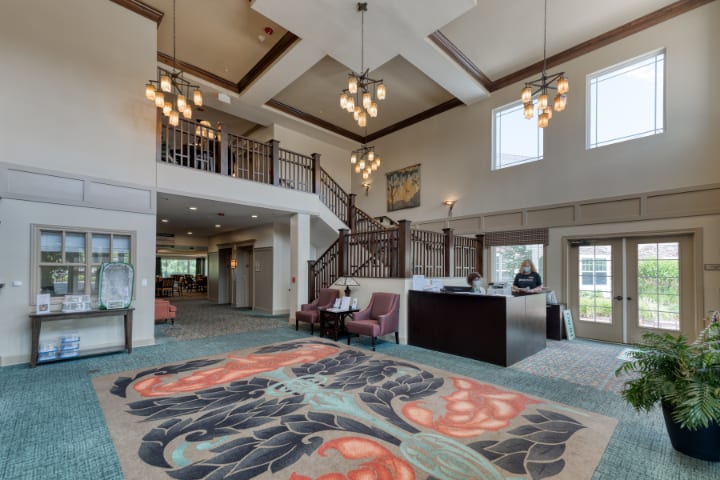 Spacious lobby with elegant decor and grand staircase.