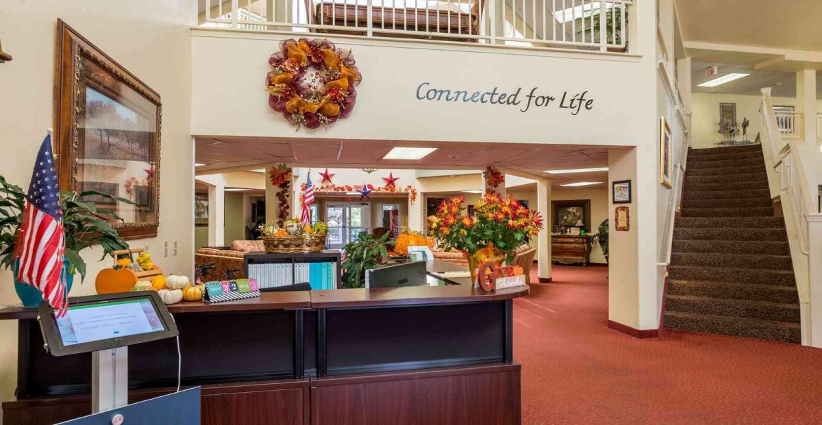 A warmly decorated reception area featuring autumn-themed decor and a welcoming sign.