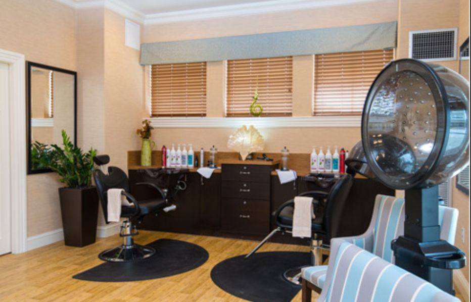A cozy hair salon interior with styling chairs and beauty products.