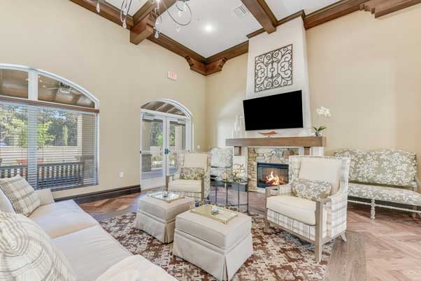 A sophisticated living room with elegant furniture and a cozy fireplace.