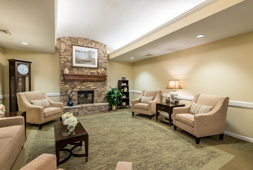 A cozy living room featuring comfortable seating and a warm fireplace, perfect for relaxation.