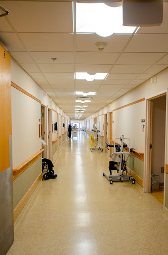 A quiet corridor in a hospital, showcasing a clean and orderly medical environment.