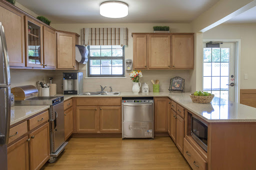A well-organized modern kitchen featuring wooden cabinets and essential appliances.
