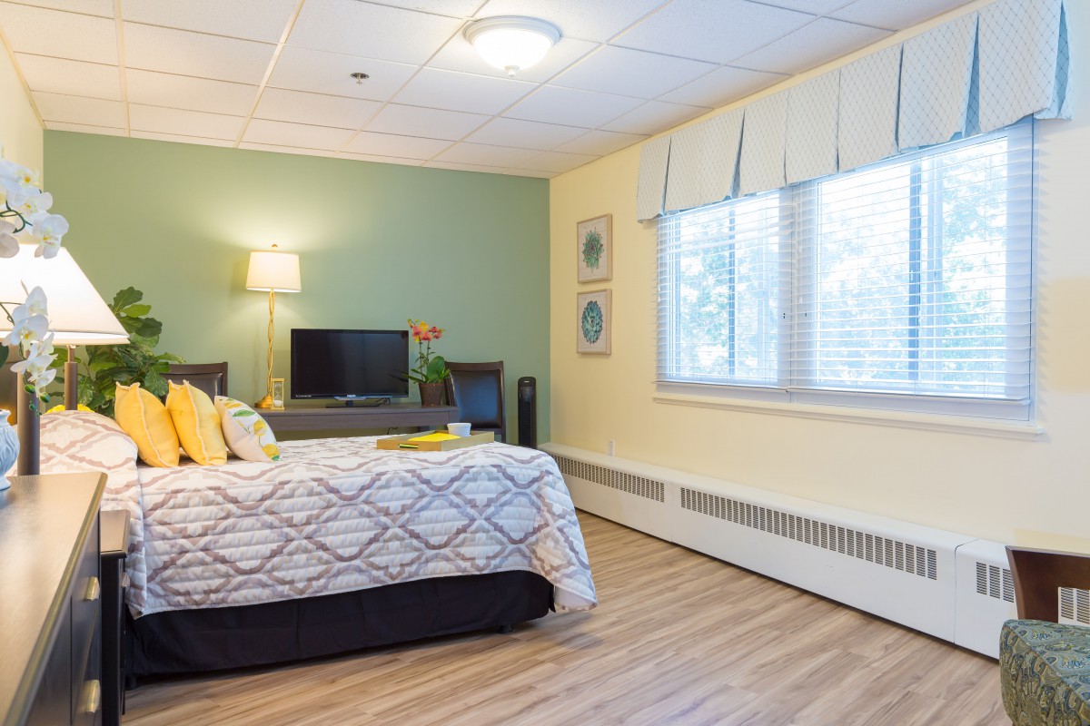 A modern bedroom with stylish decor and ample natural light.
