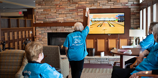 Seniors engaging in a fun bowling activity at a community center.
