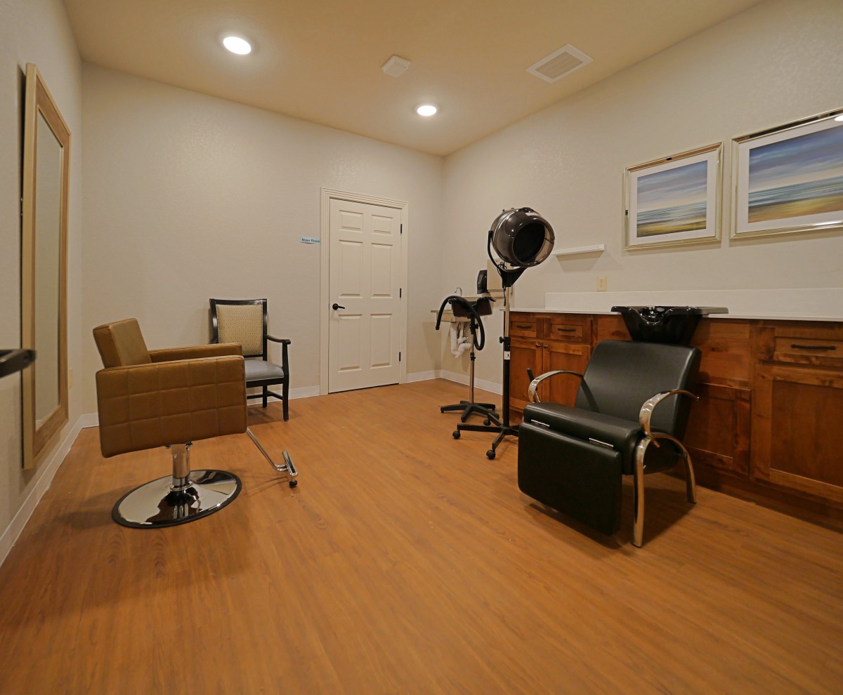 A modern hair salon interior with stylish chairs and a professional hair dryer.