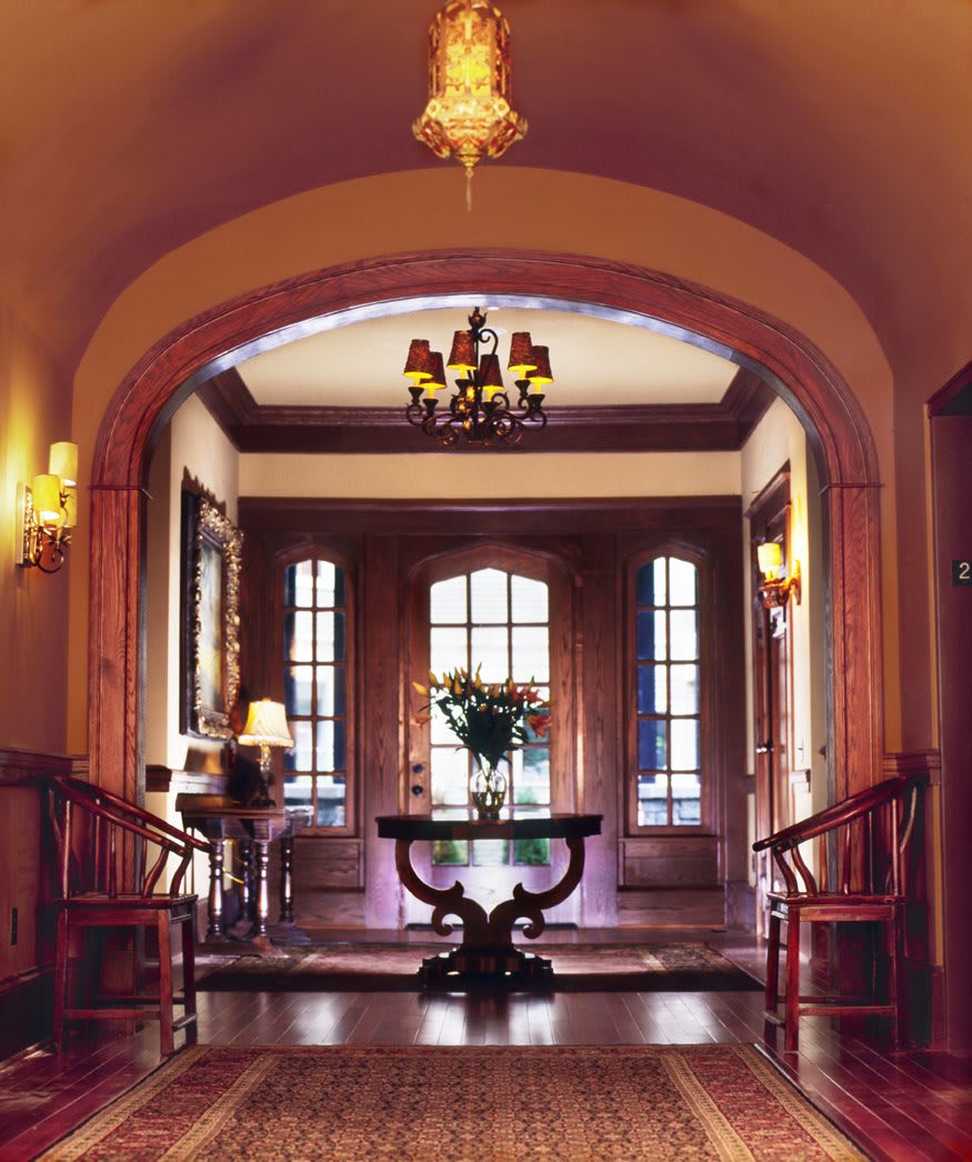 A beautifully decorated hallway featuring elegant woodwork and warm lighting.