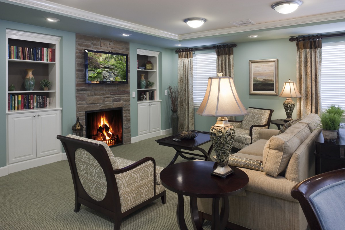 A cozy living room with a fireplace, television, and comfortable seating.