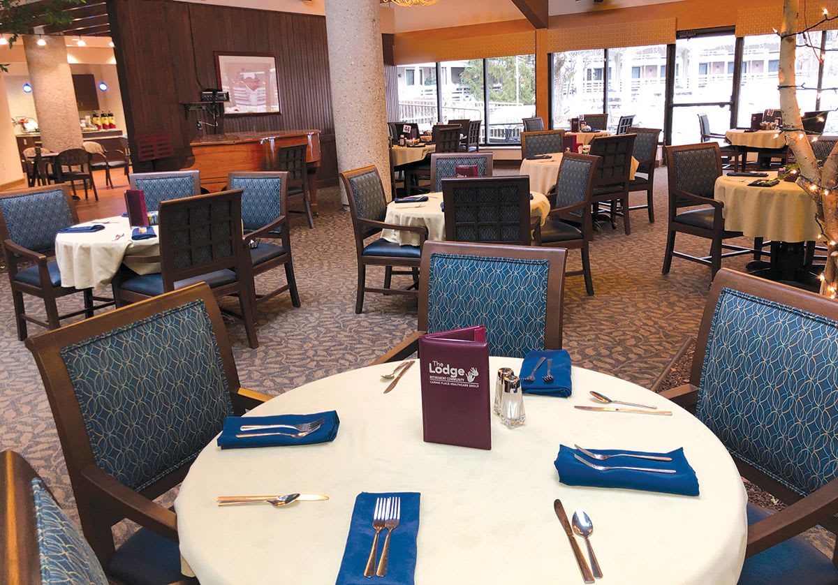 A neatly arranged restaurant dining area with tables set for guests.