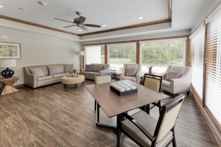 A modern living room with comfortable seating and large windows providing natural light.