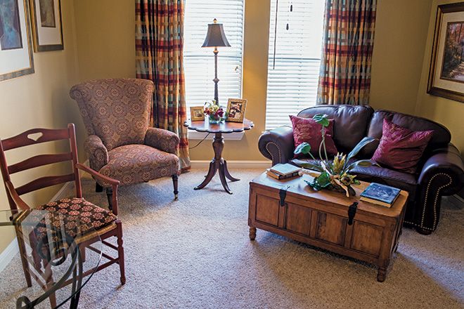 Cozy living room with classic furniture and warm lighting.