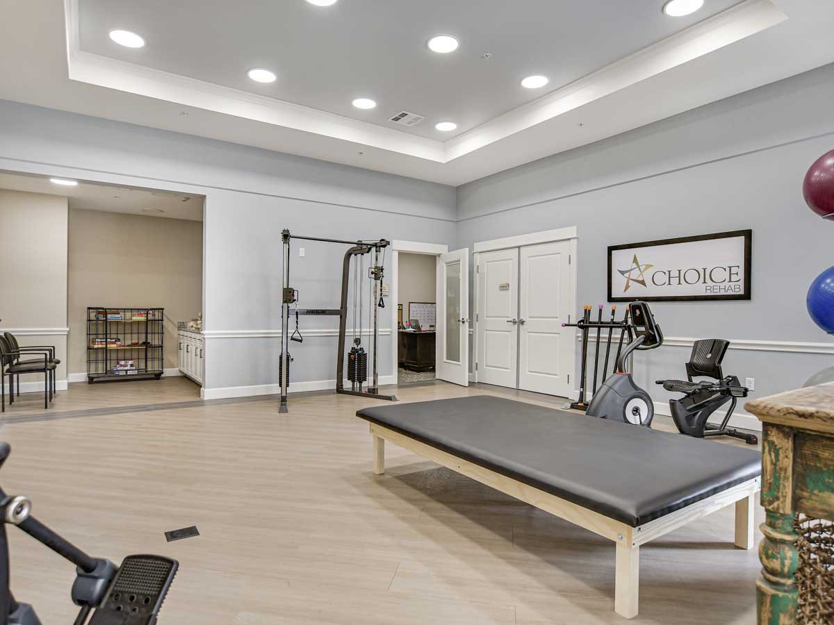 A modern gym featuring a stationary bike, exercise mat, and other fitness equipment.