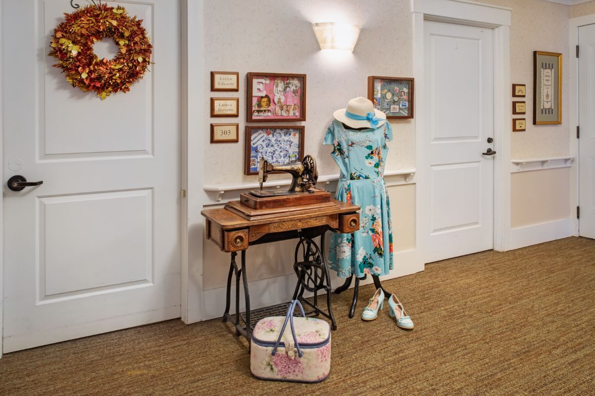 Vintage-themed decor with a sewing machine and mannequin in a hallway.