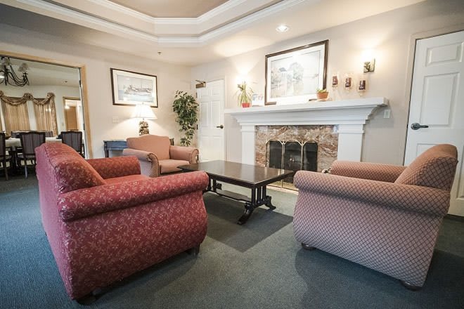 A cozy living room with comfortable seating and a fireplace.