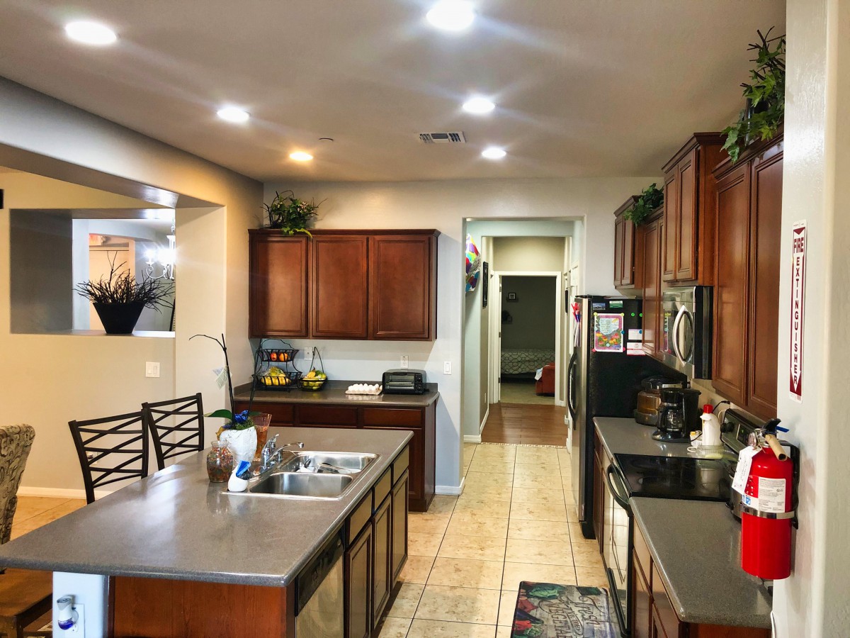 Modern kitchen with wooden cabinets and a central island.