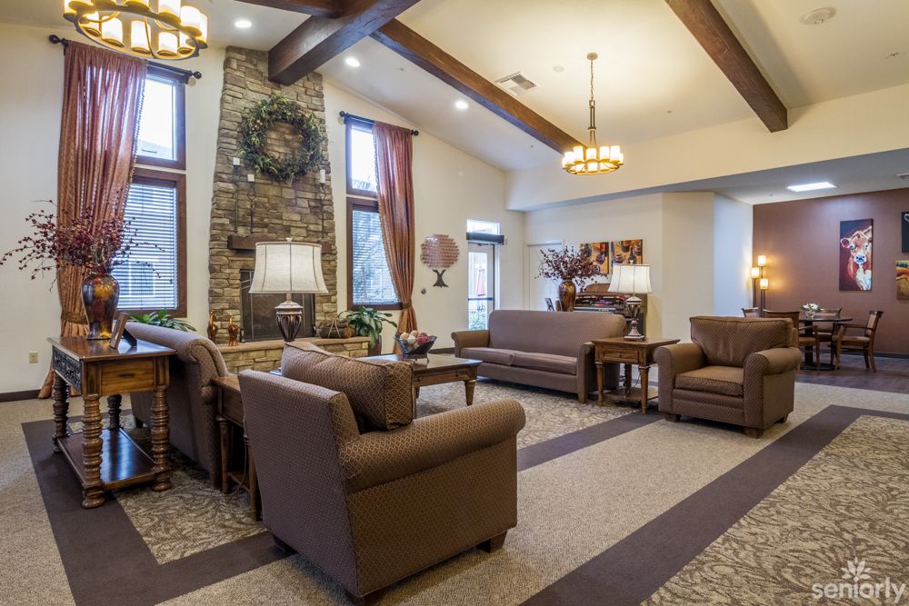 A cozy living room with comfortable furniture and a stone fireplace.
