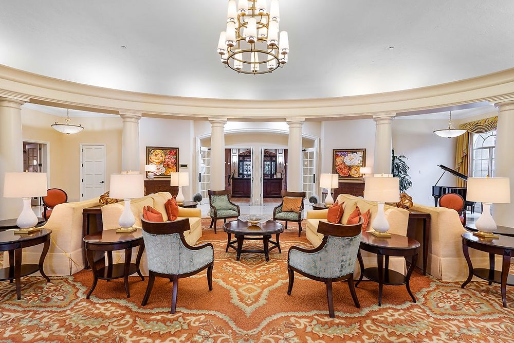 Luxurious hotel lobby with elegant seating and a grand chandelier.