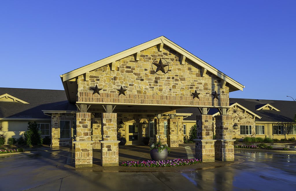 A stone building with a prominent entrance and star decorations.