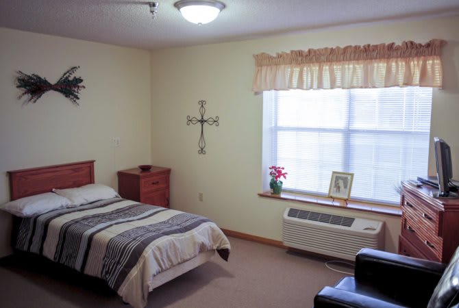 A cozy bedroom with a single bed and natural light.