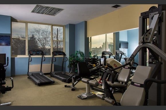 A well-equipped indoor gym featuring treadmills and stationary bikes.