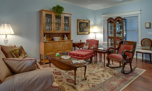 A cozy living room featuring traditional furniture and a warm color palette.