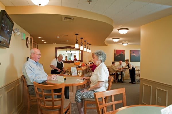 Seniors enjoying a meal in a cozy restaurant setting.