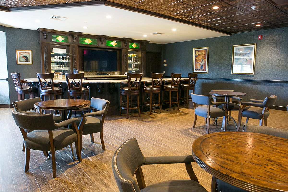 Cozy bar with seating area and well-stocked counter.