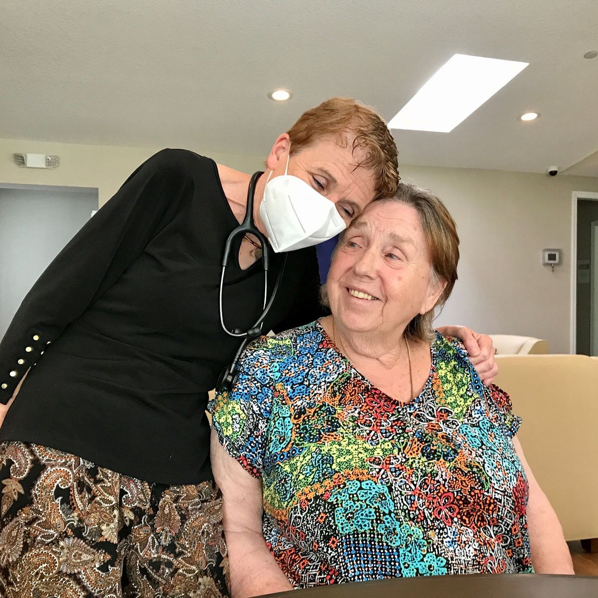 A heartwarming moment between two individuals, highlighting companionship and care.