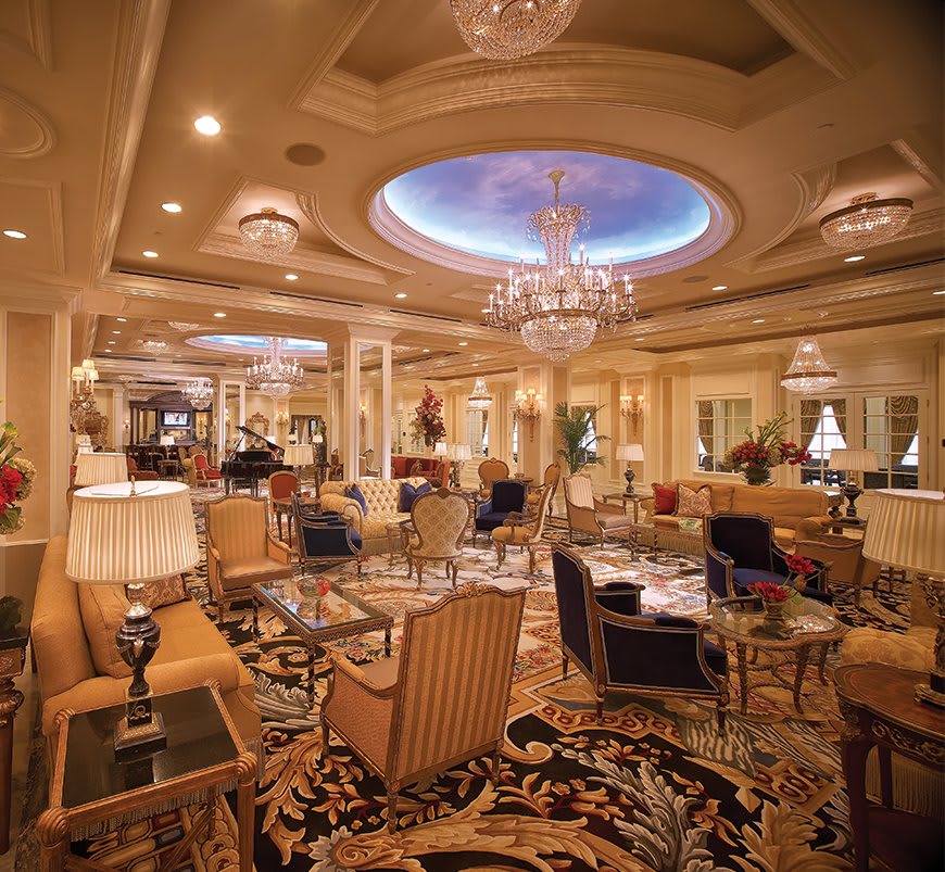 A luxurious hotel lounge adorned with elegant chandeliers and opulent furnishings.