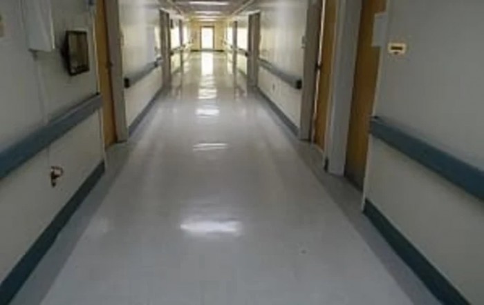 An empty corridor in a hospital setting.