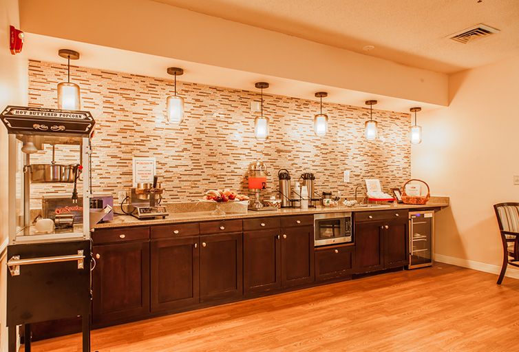 A modern kitchen with wooden cabinets, stylish pendant lighting, and a decorative backsplash.