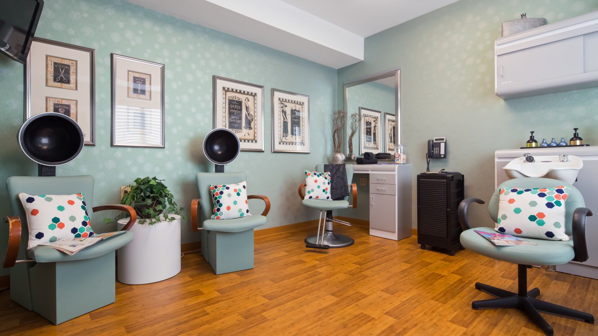 A modern hair salon interior with stylish decor and comfortable seating.