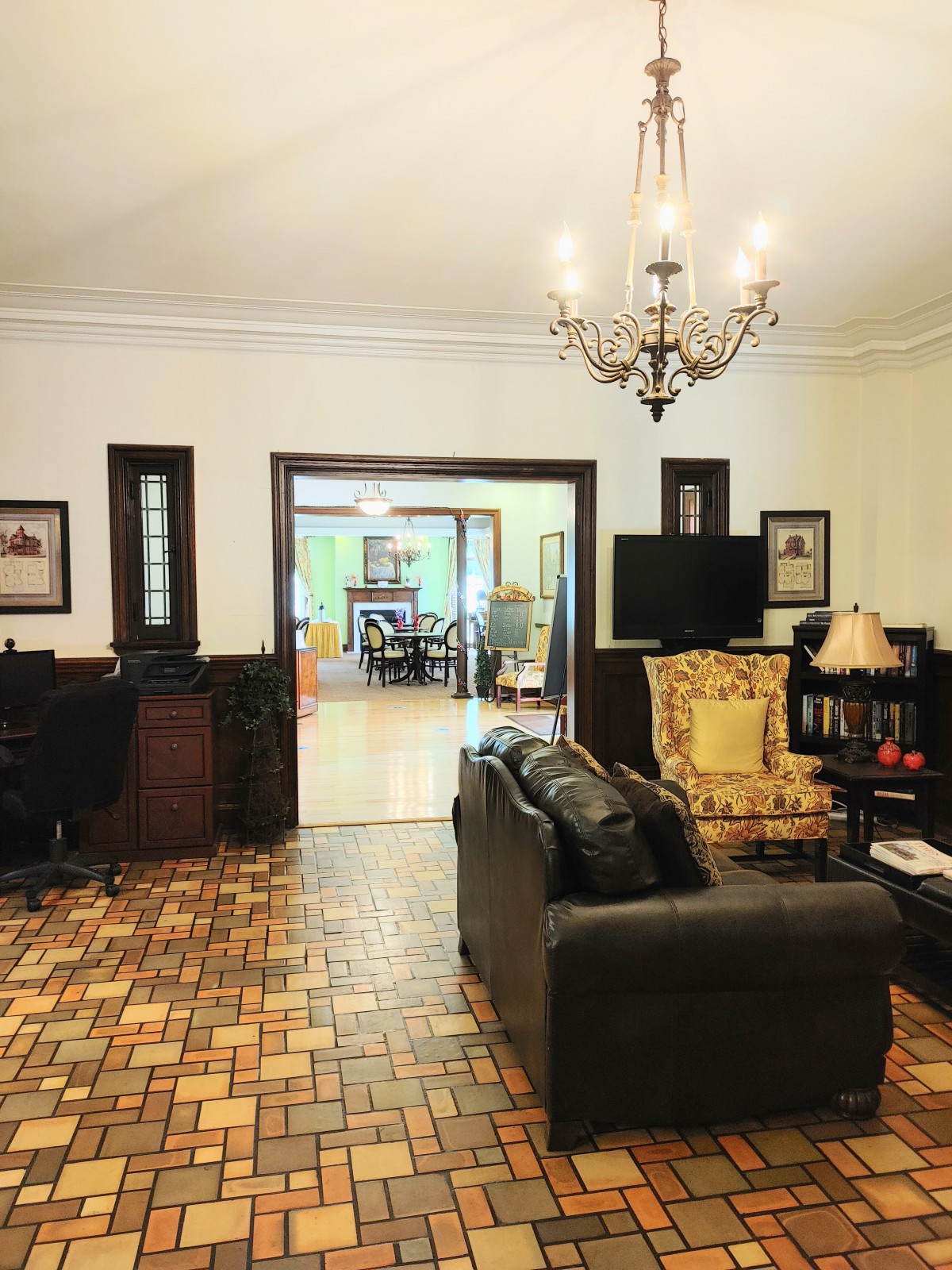 A cozy living room with elegant furniture and a chandelier.