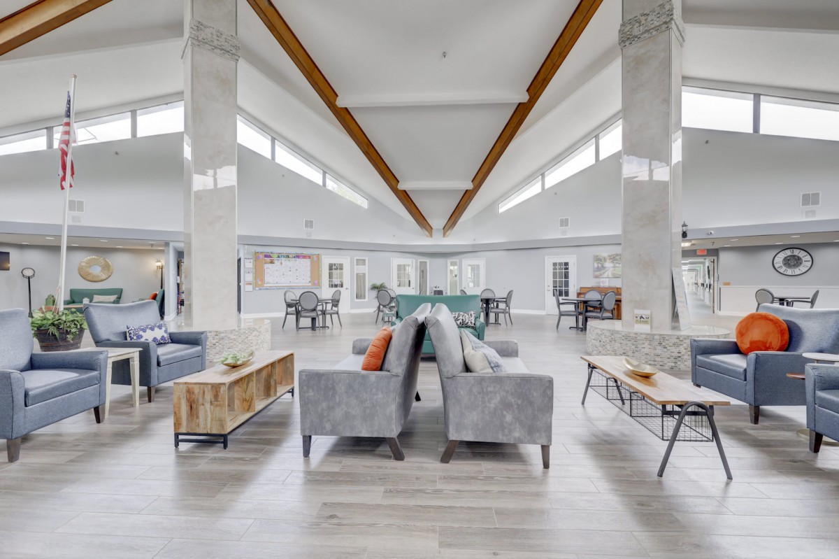A spacious and modern living room with stylish furniture and abundant natural light.