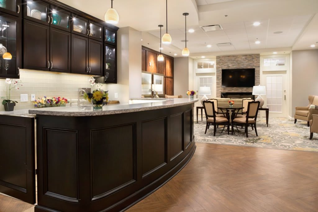A modern kitchen interior with a large island and adjoining dining area.