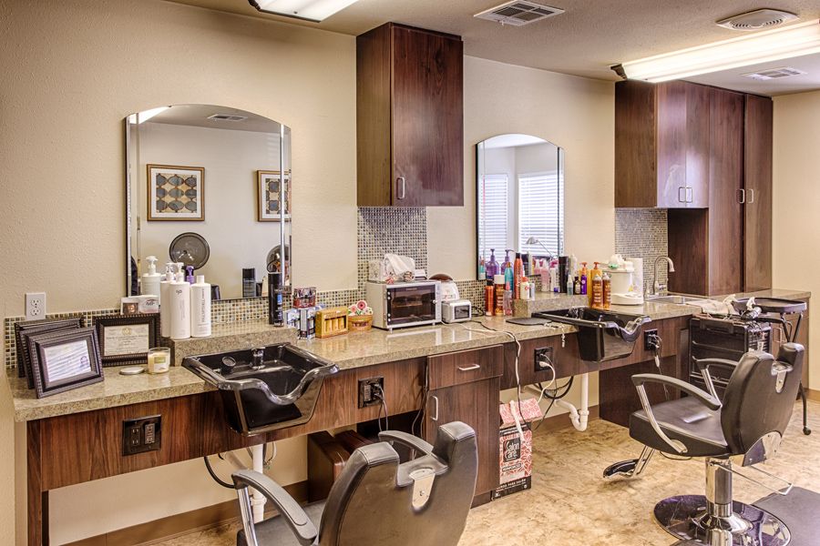 A well-equipped barbershop interior with styling chairs and mirrors.