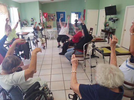 Elderly participants engage in a group exercise session, promoting physical activity and community interaction.