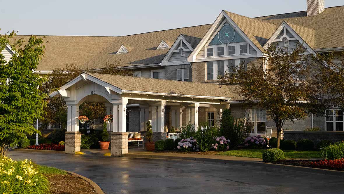 A large residential building with a welcoming entrance and landscaped front yard.