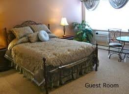 Cozy guest room with a neatly made bed and warm lighting.