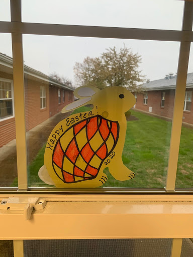 A cheerful turtle decoration on a window, adding color to the indoor space.