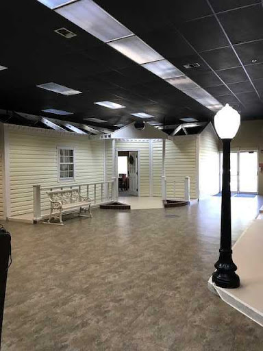 A spacious, modern interior showcasing an open layout with decorative light fixtures.