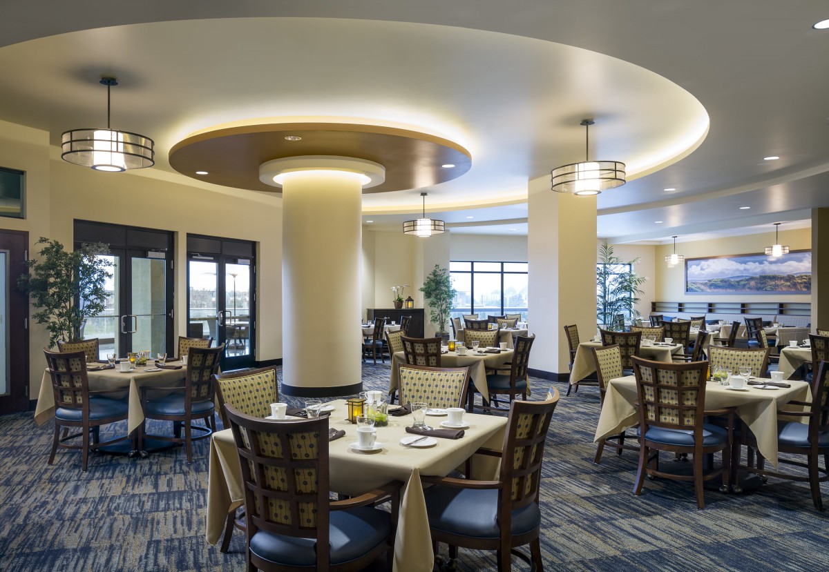A modern and elegant dining room with stylish lighting and well-arranged tables.