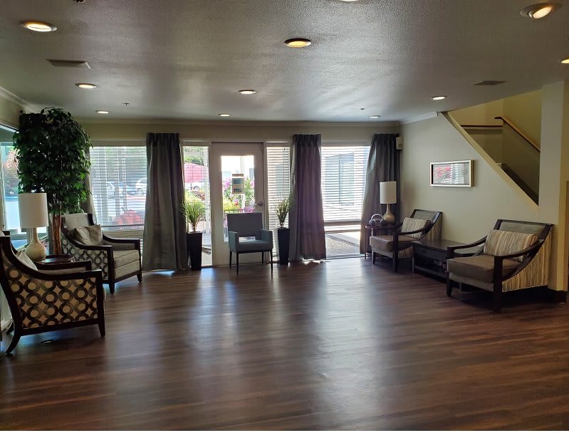 A spacious lobby area featuring comfortable seating and elegant wood flooring.