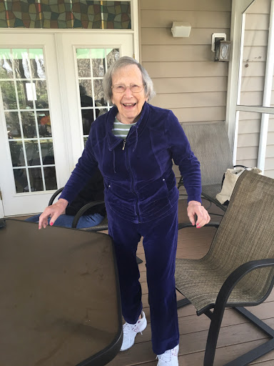 An elderly woman joyfully enjoying her time outdoors.