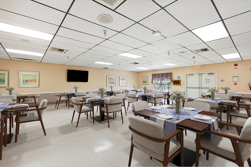 A spacious and modern dining area featuring neatly arranged tables and chairs.