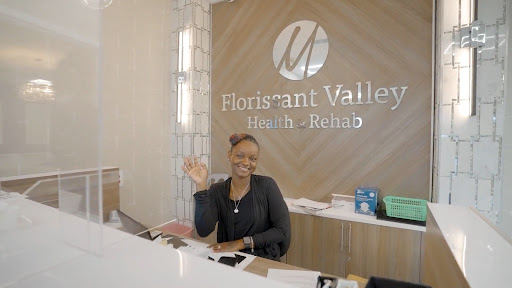 A welcoming receptionist at Florissant Valley Health & Relax, ready to assist visitors.