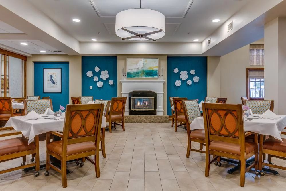A modern dining room featuring elegant decor, comfortable seating, and a cozy fireplace.